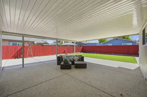 a view of yard with patio