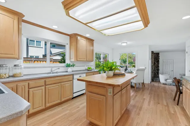 a kitchen with sink cabinets and wooden floor