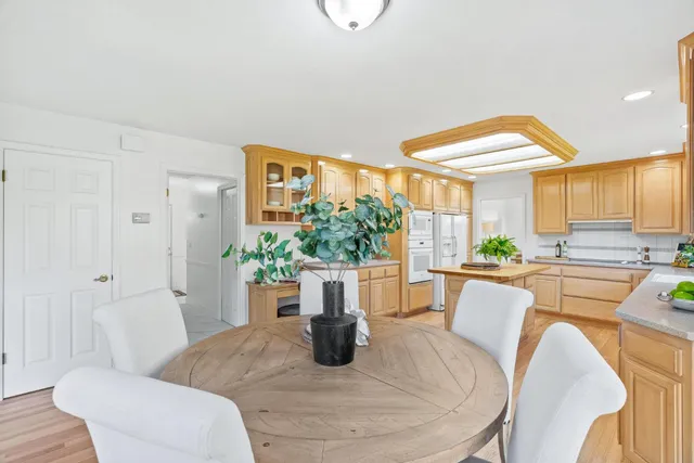 a dining room with furniture and a large window