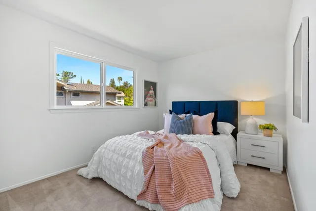 a bedroom with bed and a window