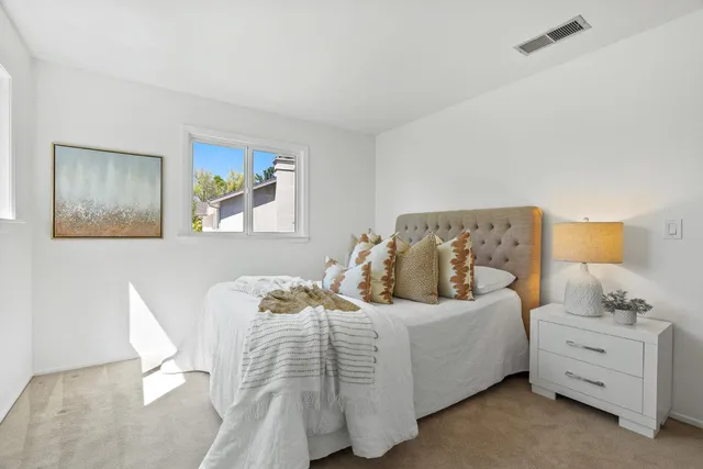 a bedroom with a bed and window