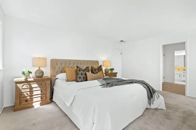 a bedroom with a bed and dresser