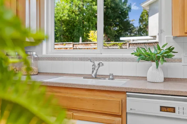 a vase of flowers sitting on a table with a window