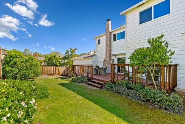 a view of a house with a yard and sitting area