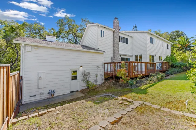 a view of a house with backyard and sitting area