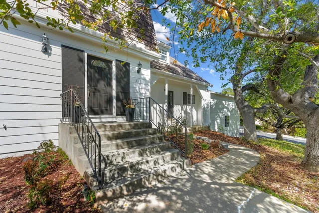 a view of a house with backyard and tree
