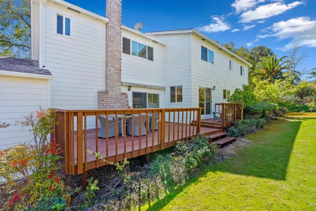 a view of a house with wooden fence