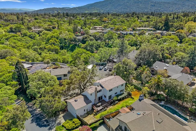 an aerial view of a house with a yard