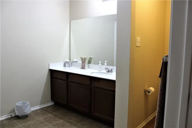 a bathroom with a shower and a chair