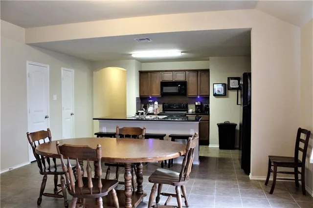 a kitchen with stainless steel appliances granite countertop a sink and a stove