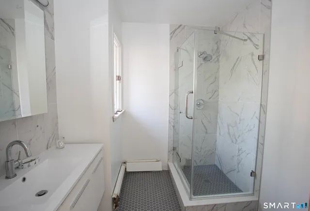 a room with pool table and windows