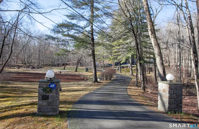 a park view with iron fence and trees