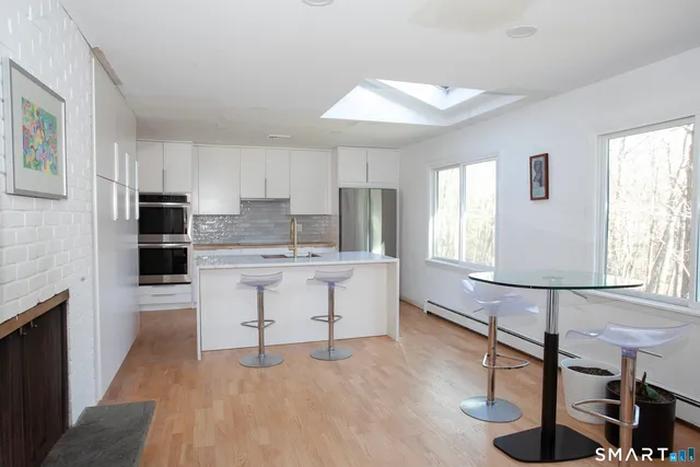 a kitchen with counter top space cabinets and appliances