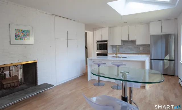 a kitchen with kitchen island cabinets and refrigerator