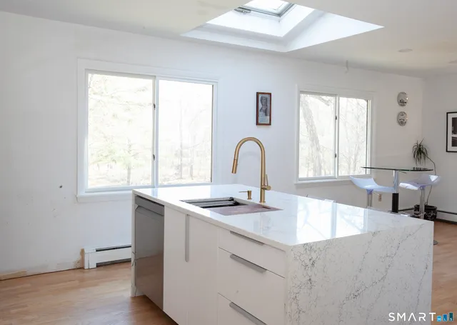 a living room with furniture flat screen tv and a fireplace