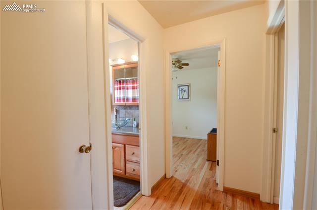 2124 North Chelton Road Colorado Springs, CO 80909 - Photo 12 of 36 Main Level Hallway to Bedrooms and Bathroom