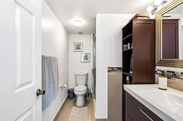 a bathroom with a sink toilet and shower