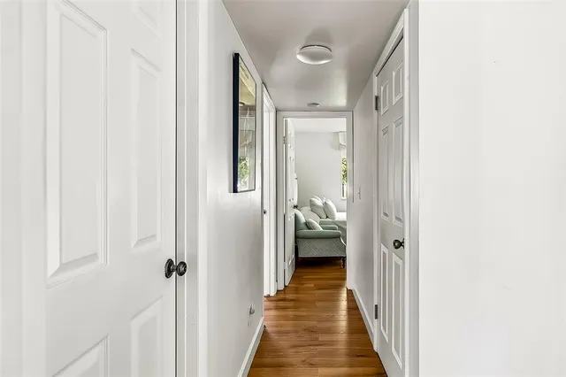 a view of a hallway with a wooden door