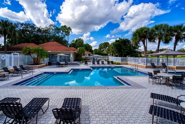 a view of backyard with seating space and trees