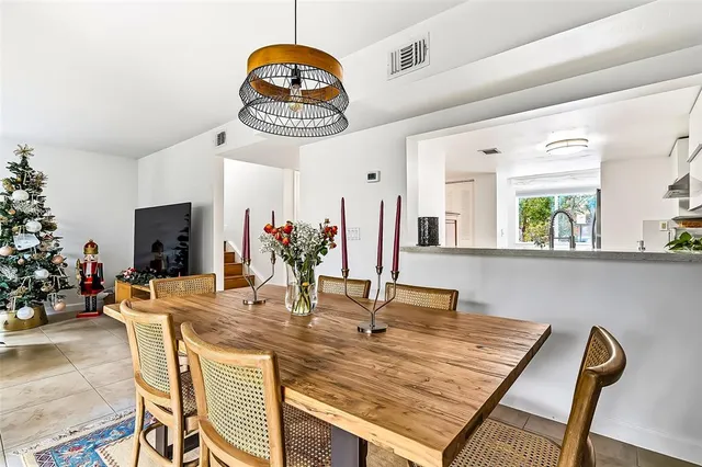 a view of a kitchen with kitchen island dining table and chairs
