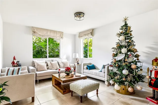 a living room with furniture and a potted plant
