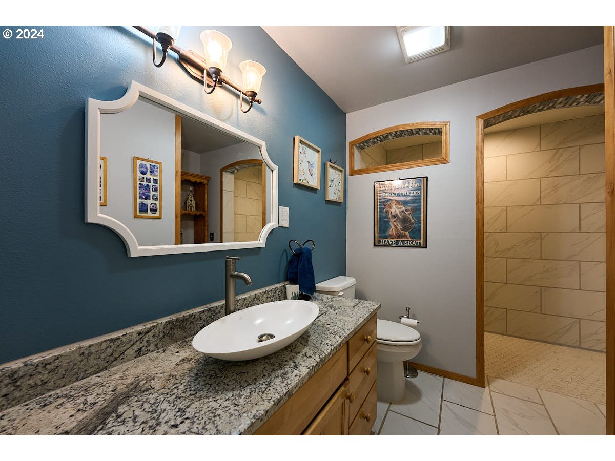 76012 Highway 82 Elgin, OR 97827 - Photo 12 of 41 a bathroom with a sink and a mirror