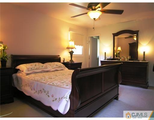 12 Spring Street Somerset, NJ 08873 - Photo 14 of 24 a bedroom with a bed and a chandelier