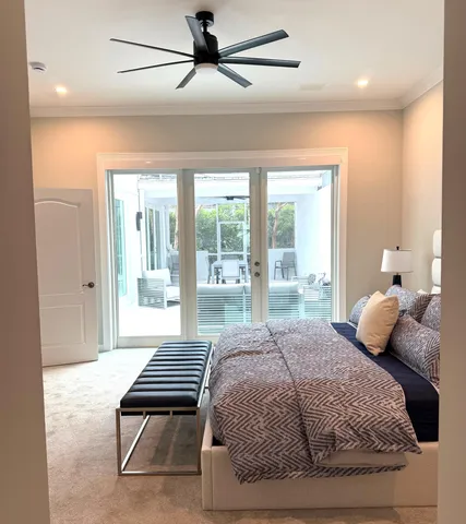 a bedroom with a bed and a large window