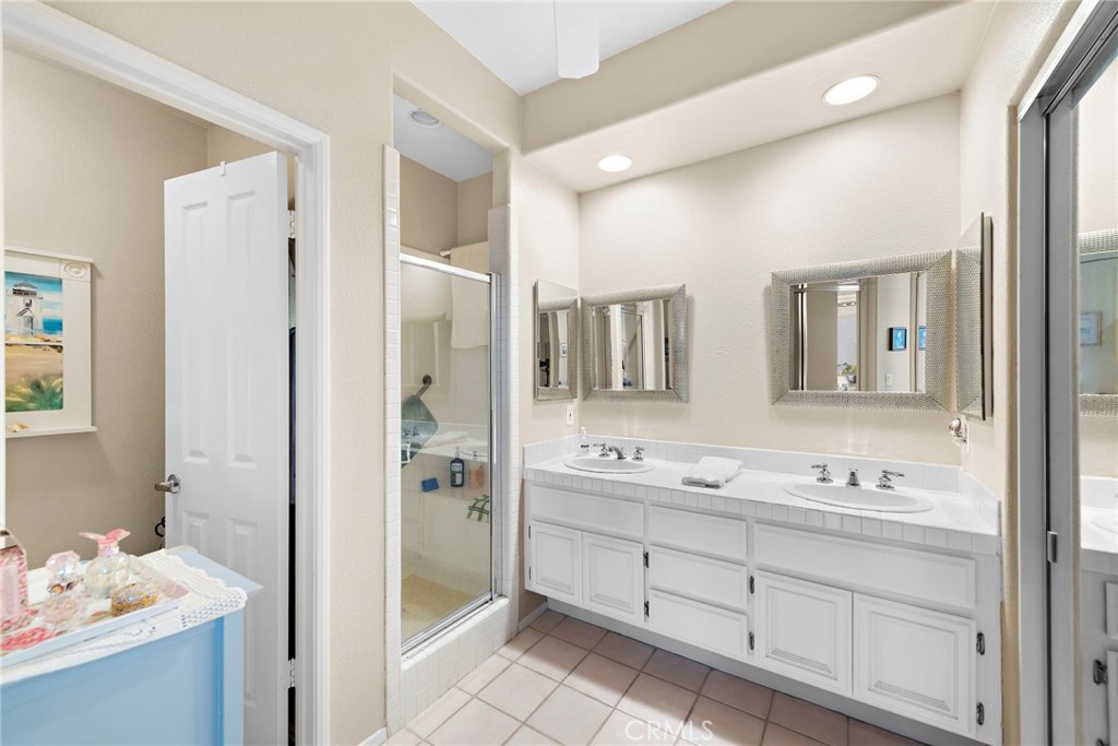 21191 Cancun Mission Viejo, CA 92692 - Photo 11 of 28 a spacious bathroom with a double vanity sink mirror and double
