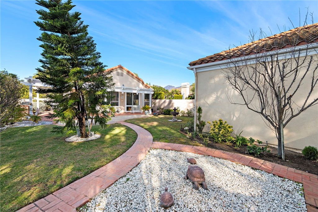 21191 Cancun Mission Viejo, CA 92692 - Photo 24 of 28 a front view of a house with garden