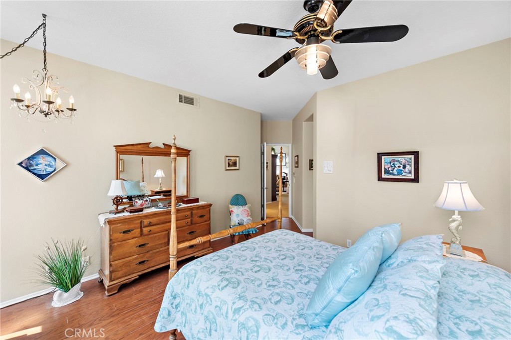 21191 Cancun Mission Viejo, CA 92692 - Photo 10 of 28 a bedroom with a bed and a chandelier