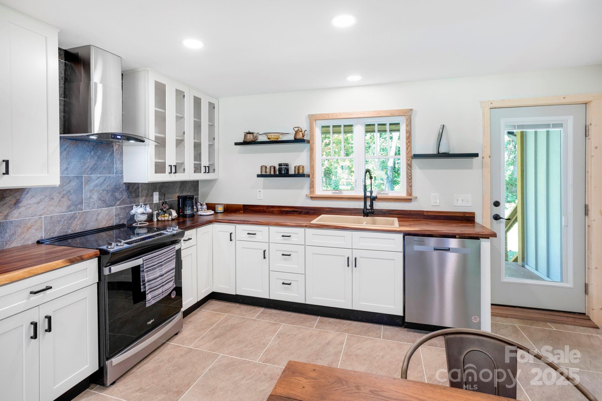 1808 Allens Creek Road Waynesville, NC 28786 - Photo 11 of 45 a kitchen with a sink stove and cabinets