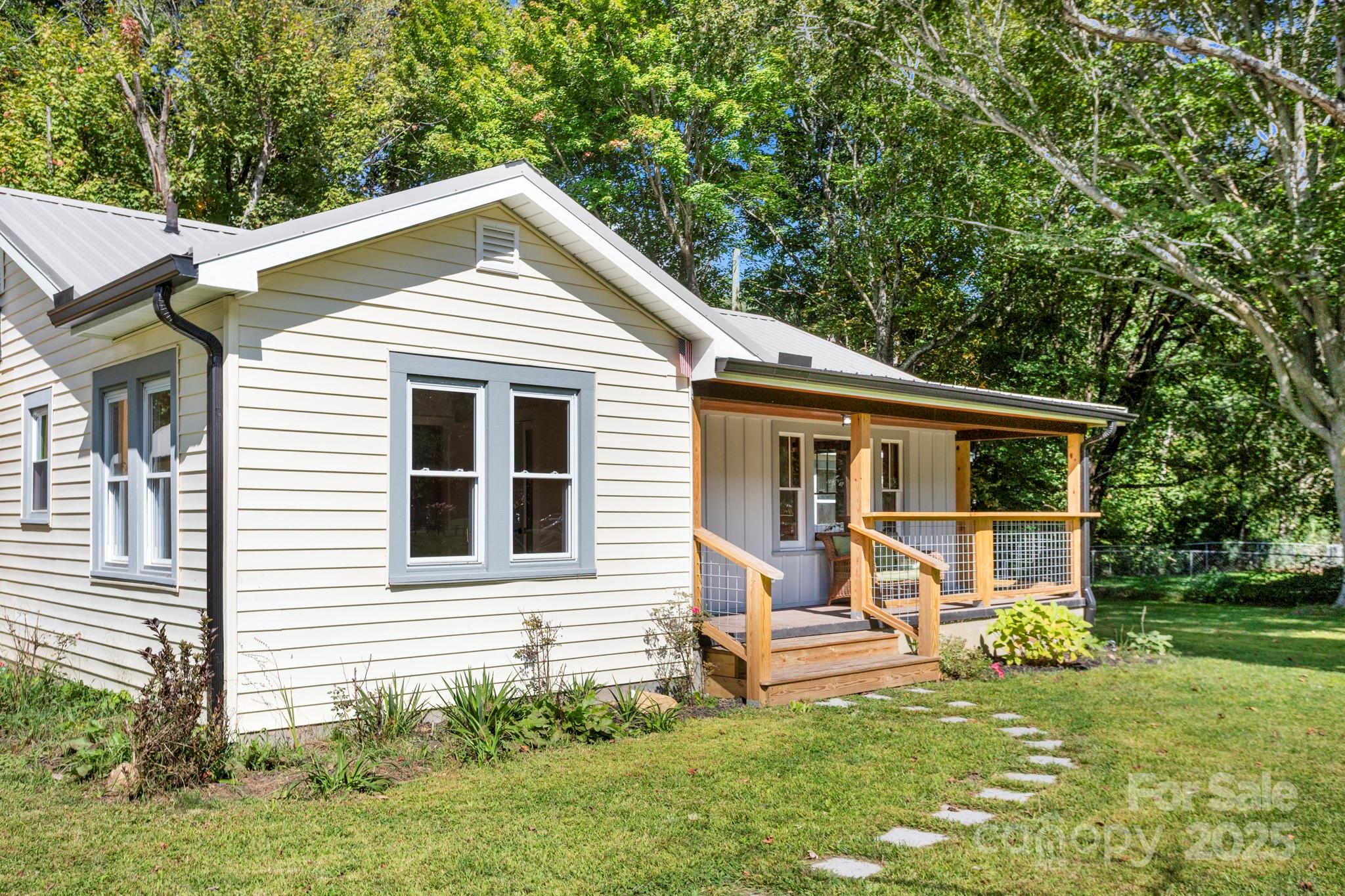 1808 Allens Creek Road Waynesville, NC 28786 - Photo 2 of 45 a front view of a house with a yard and porch