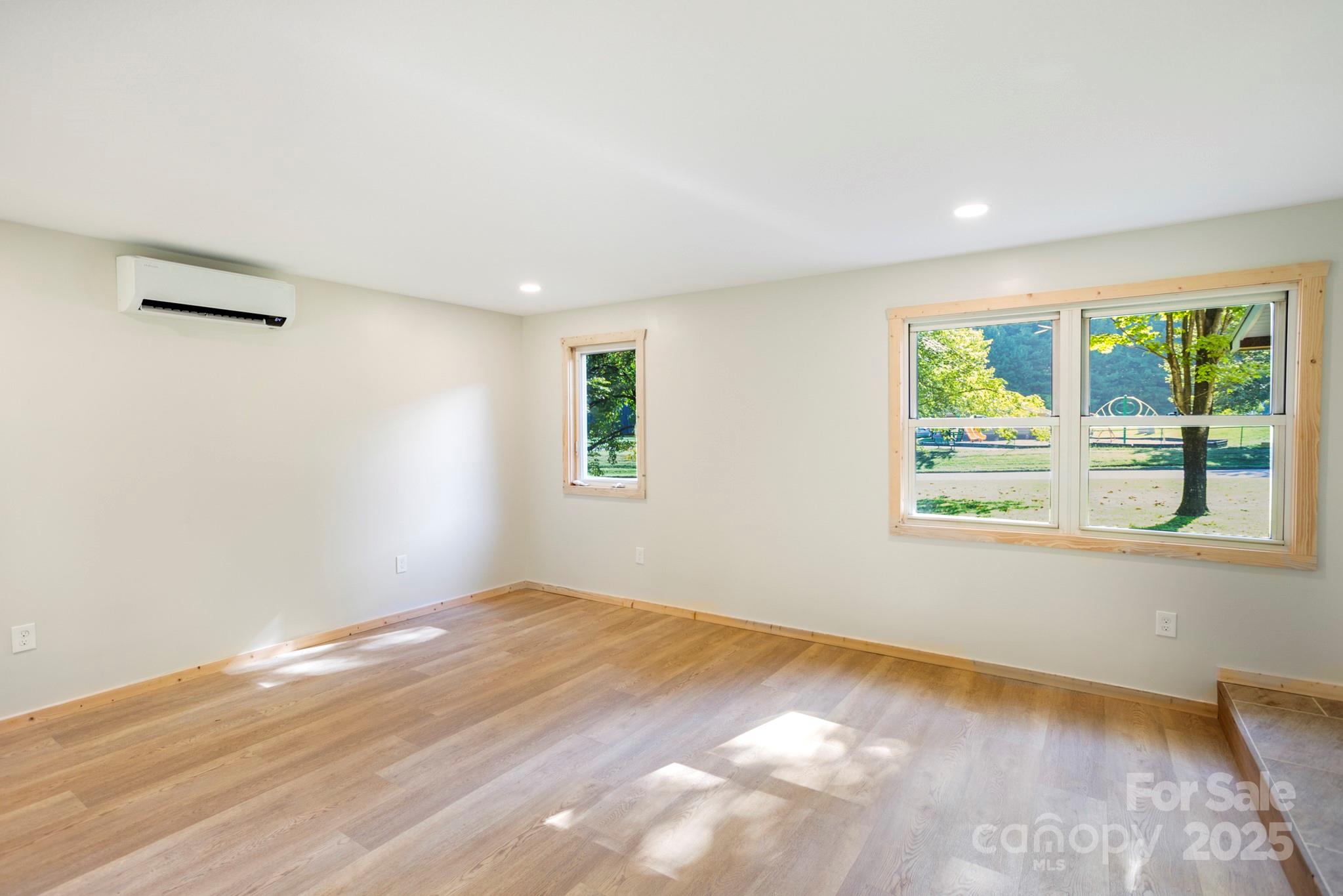 1808 Allens Creek Road Waynesville, NC 28786 - Photo 27 of 45 a view of empty room with wooden floor and fan