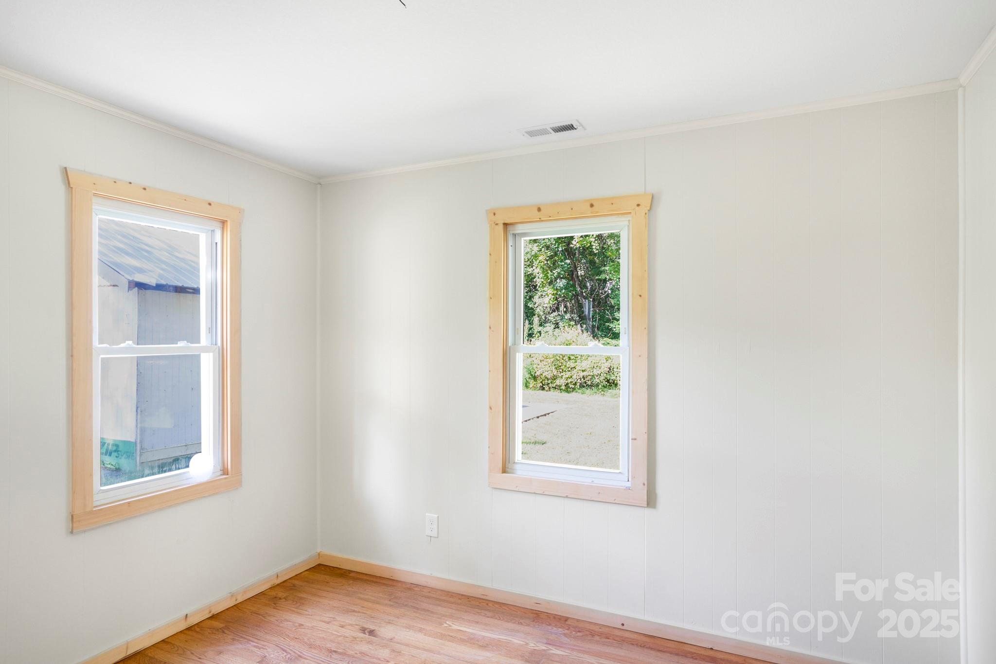 1808 Allens Creek Road Waynesville, NC 28786 - Photo 39 of 45 an empty room with wooden floor and windows