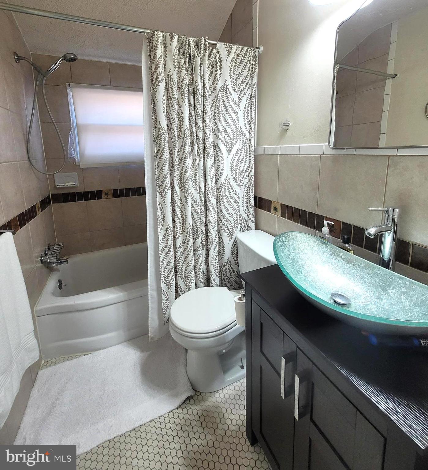 8035 Kimberly Road Dundalk, MD 21222 - Photo 6 of 8 a bathroom with a sink toilet and shower