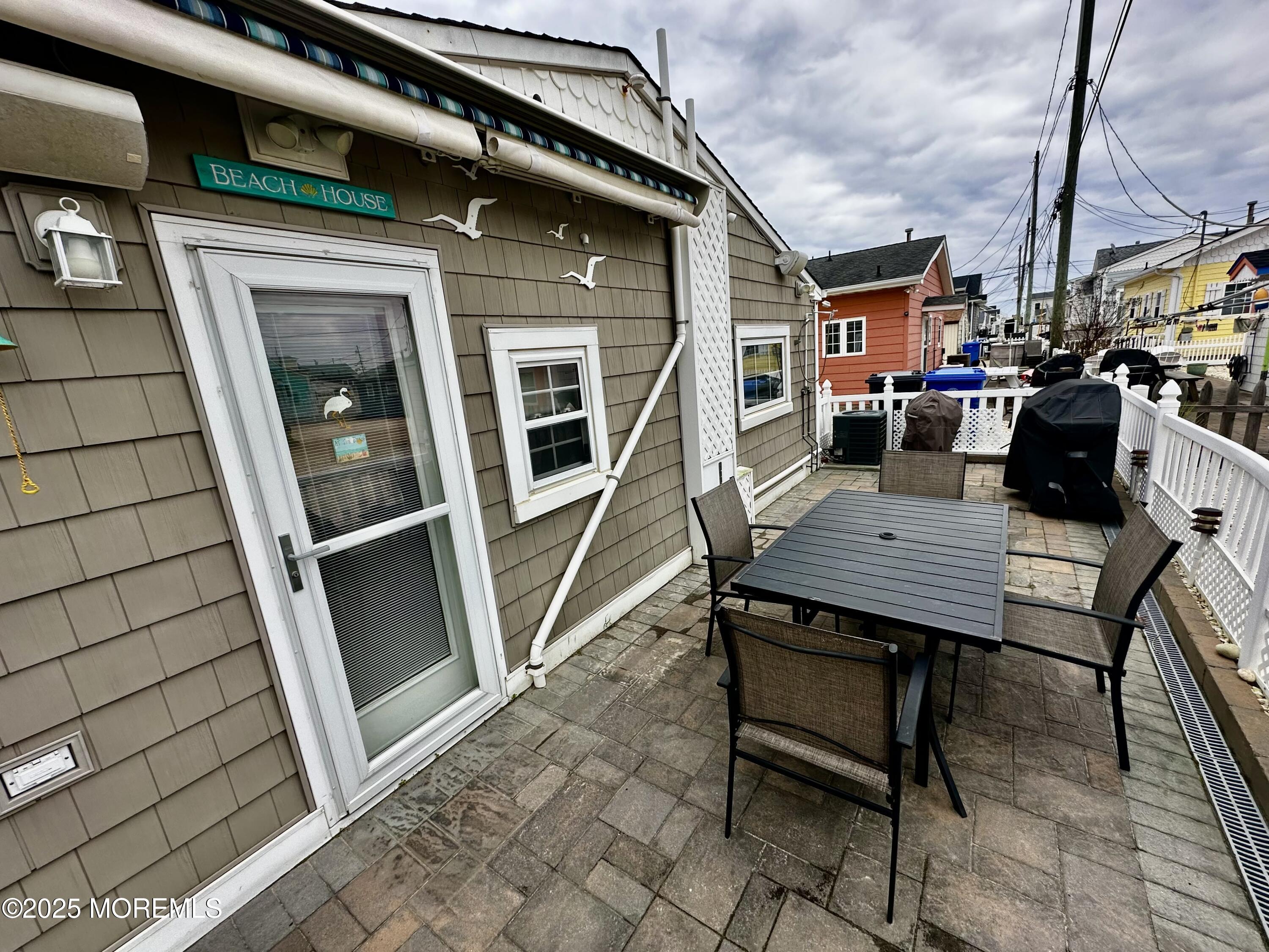 37 East Flamingo Way Lavallette, NJ 08735 - Photo 14 of 17 a backyard of a house with barbeque oven table and chairs
