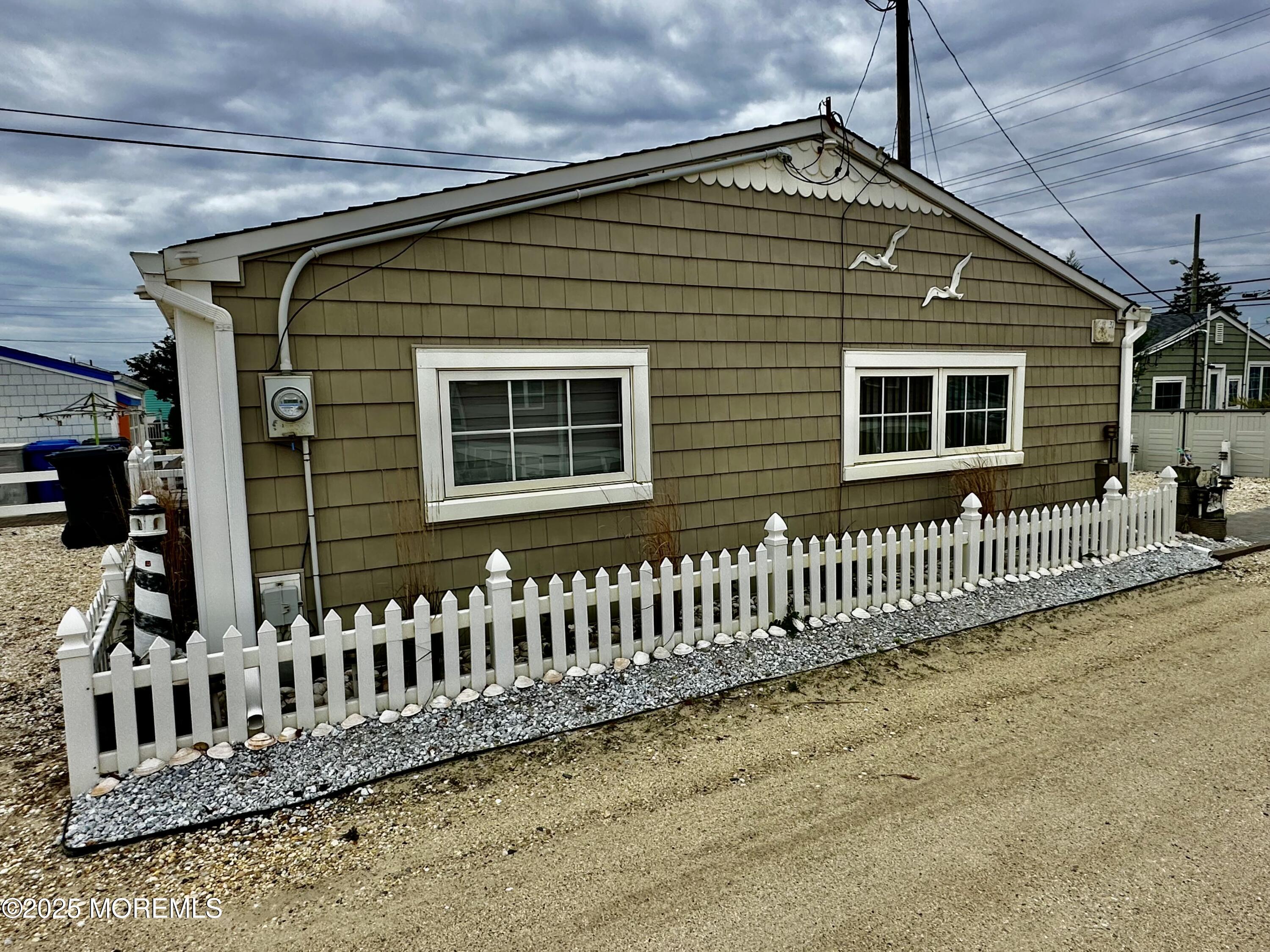 37 East Flamingo Way Lavallette, NJ 08735 - Photo 17 of 17 a front view of a house with fence