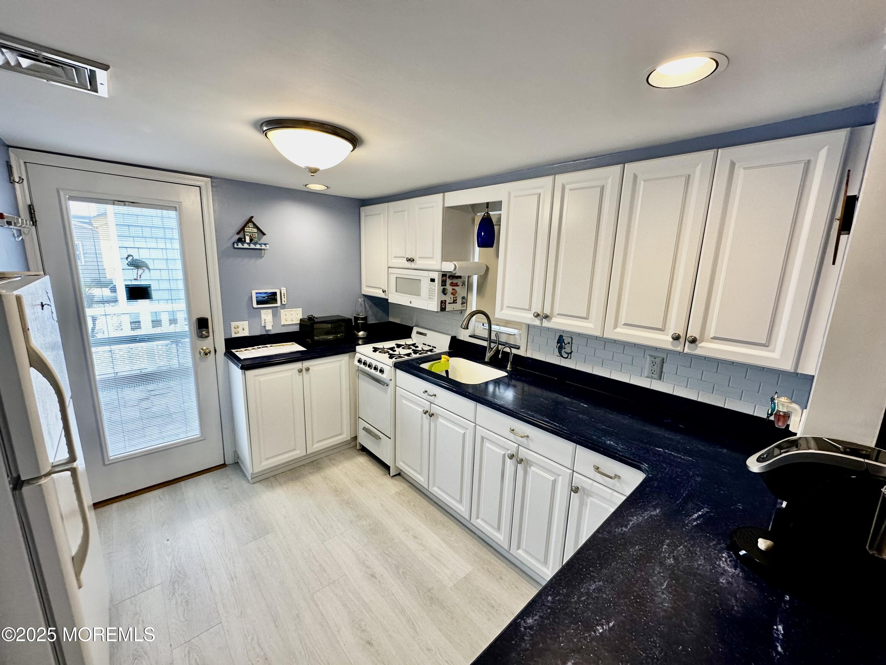 37 East Flamingo Way Lavallette, NJ 08735 - Photo 2 of 17 a large kitchen with granite countertop a sink and cabinets