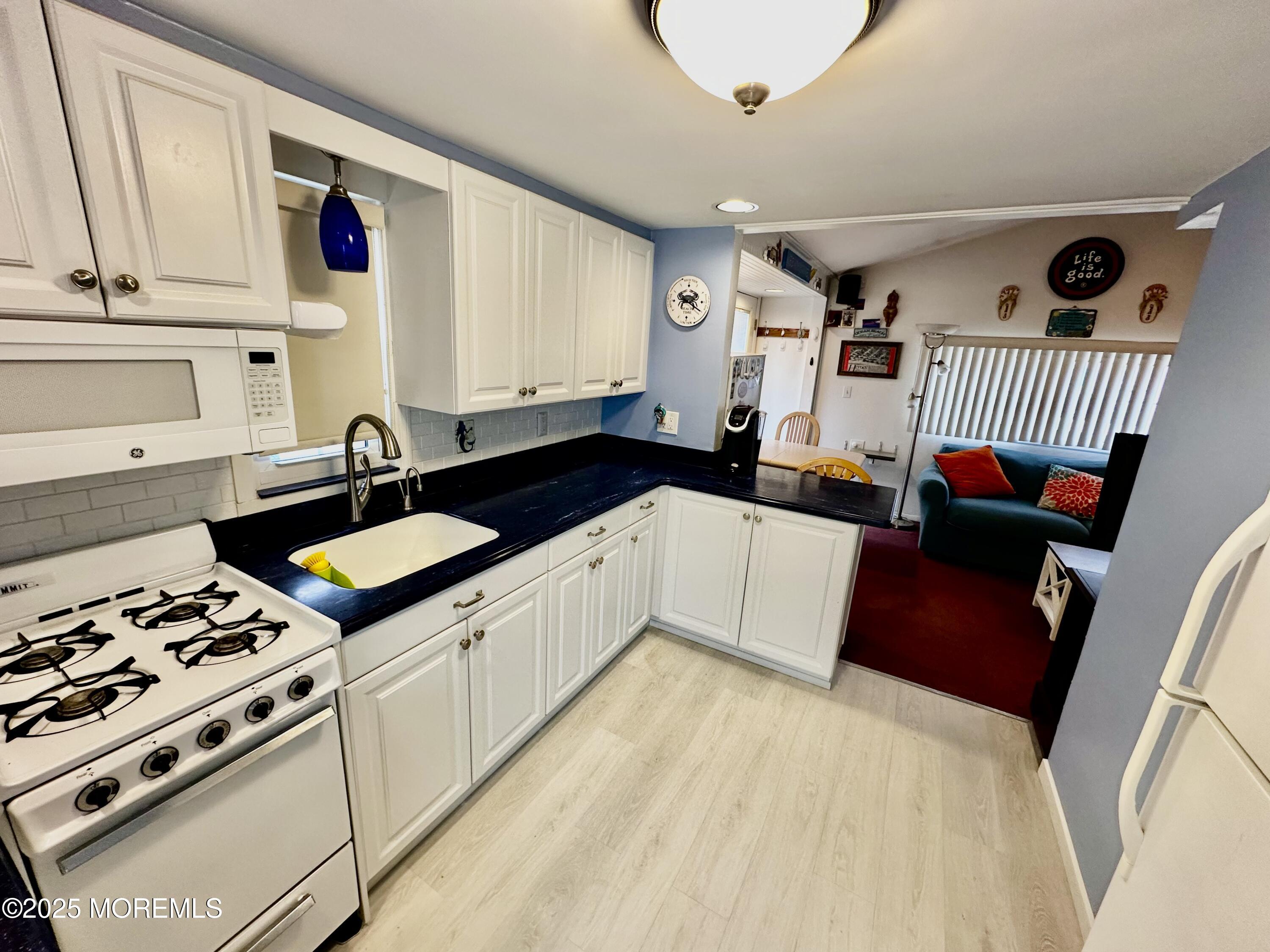 37 East Flamingo Way Lavallette, NJ 08735 - Photo 3 of 17 a kitchen with a sink stove and cabinets