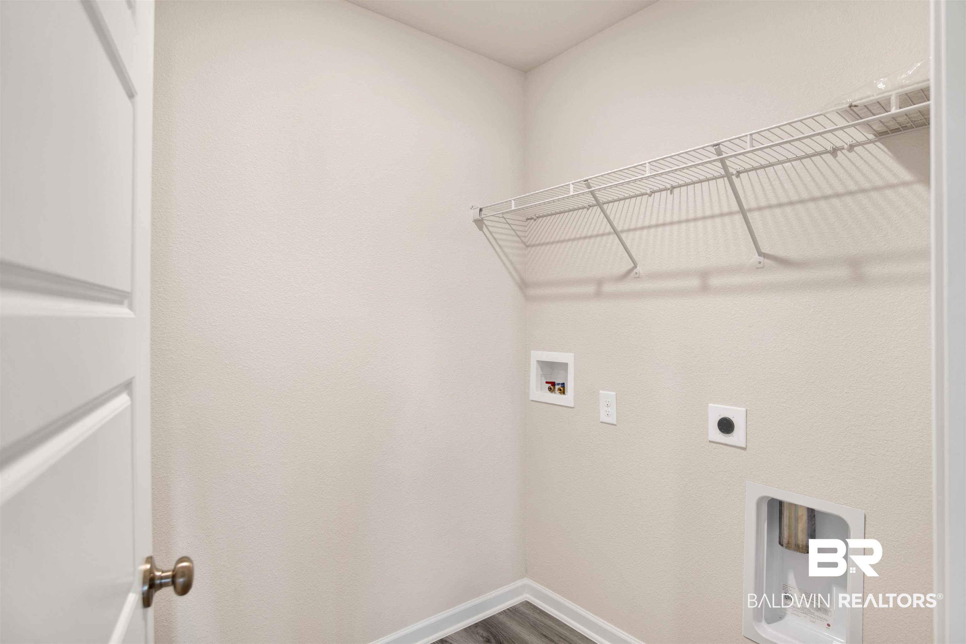 32038 Lyon Road Daphne, AL 36527 - Photo 11 of 30 Laundry area with washer hookup, hookup for an electric dryer, and dark wood finished floors