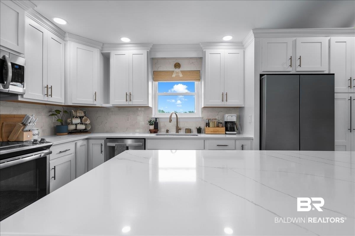 8952 Sherman Road Foley, AL 36535 - Photo 16 of 41 Expansive kitchen island with a light-toned countertop featuring subtle veining