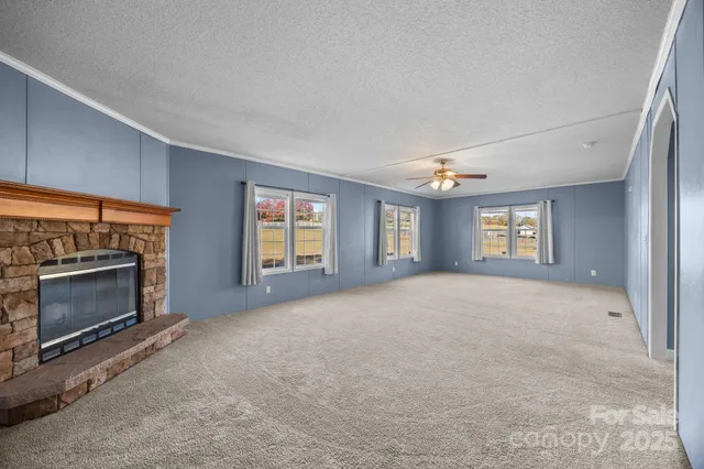 a view of empty room with a fireplace