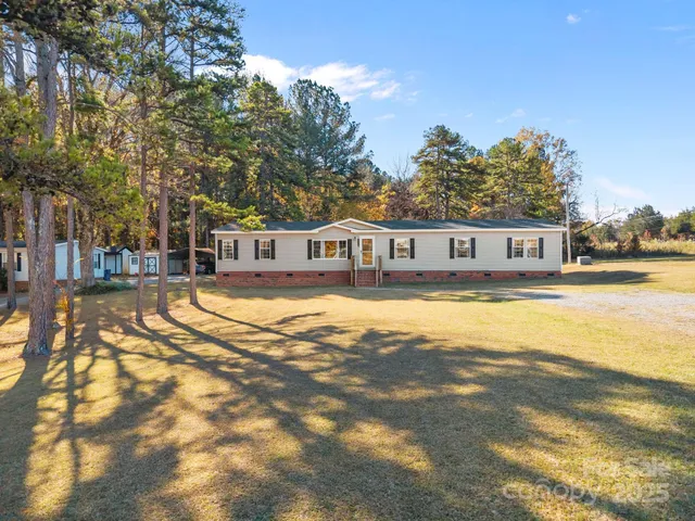 a house view with swimming pool in front of it