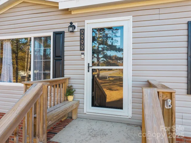 a view of front door of house with stairs