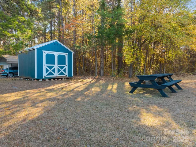 a backyard of a house with table and chairs