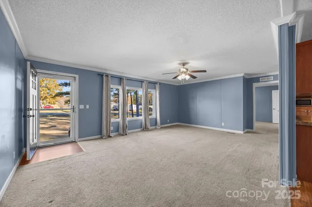 a view of an empty room with a fireplace