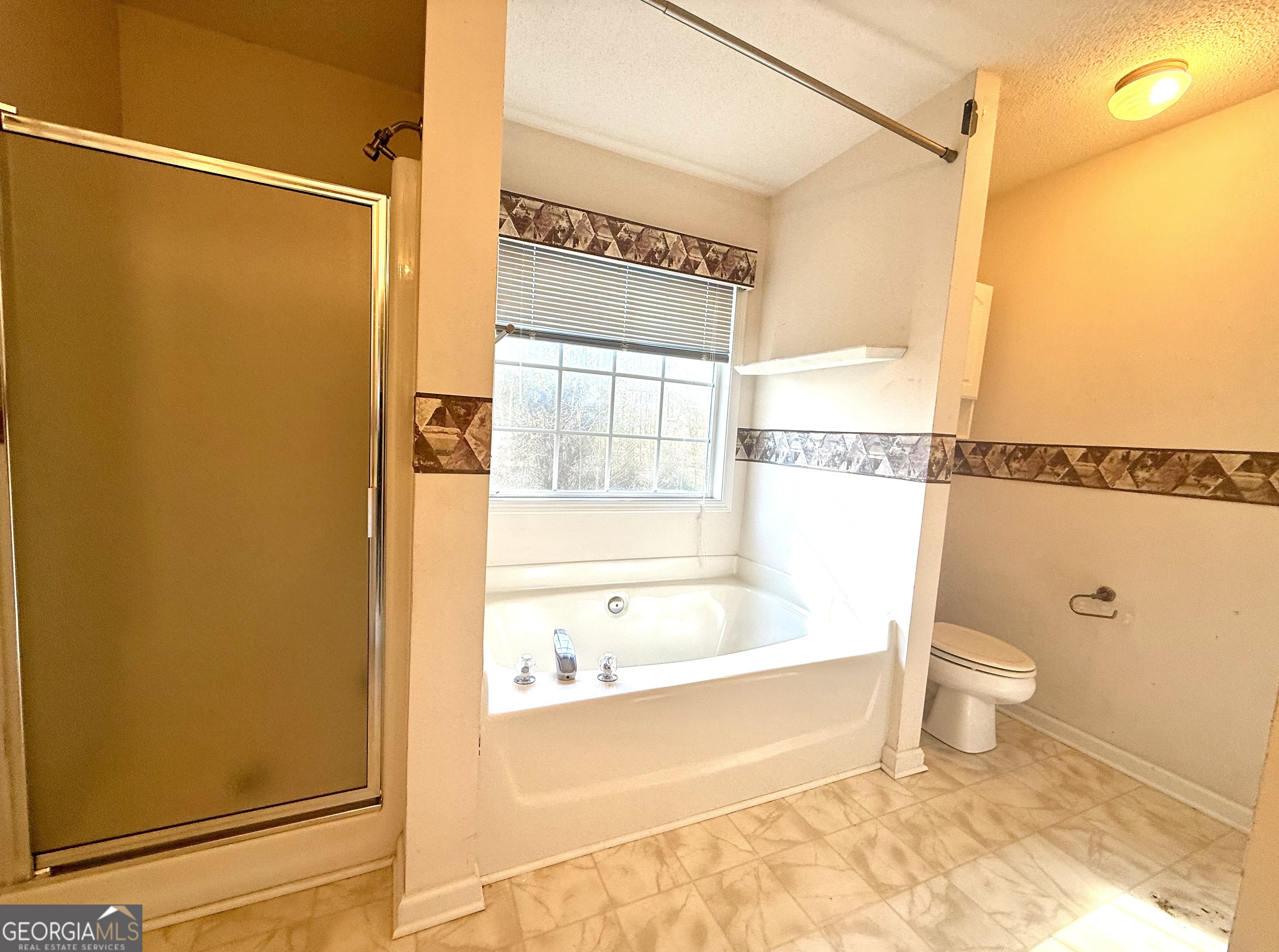 230 Mels Way Stockbridge, GA 30281 - Photo 17 of 40 a bathroom with a bathtub and a shower