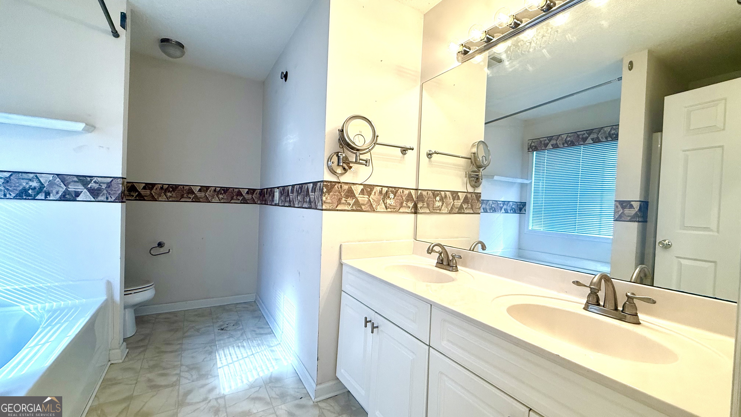 230 Mels Way Stockbridge, GA 30281 - Photo 18 of 40 a bathroom with a tub sink and mirror