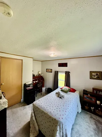 a bedroom with a bed and window